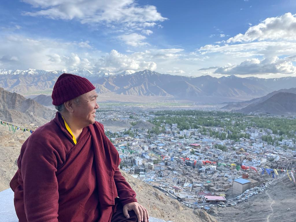 Nedo Kuchung Rinpoche overlooking a Himalayan valley