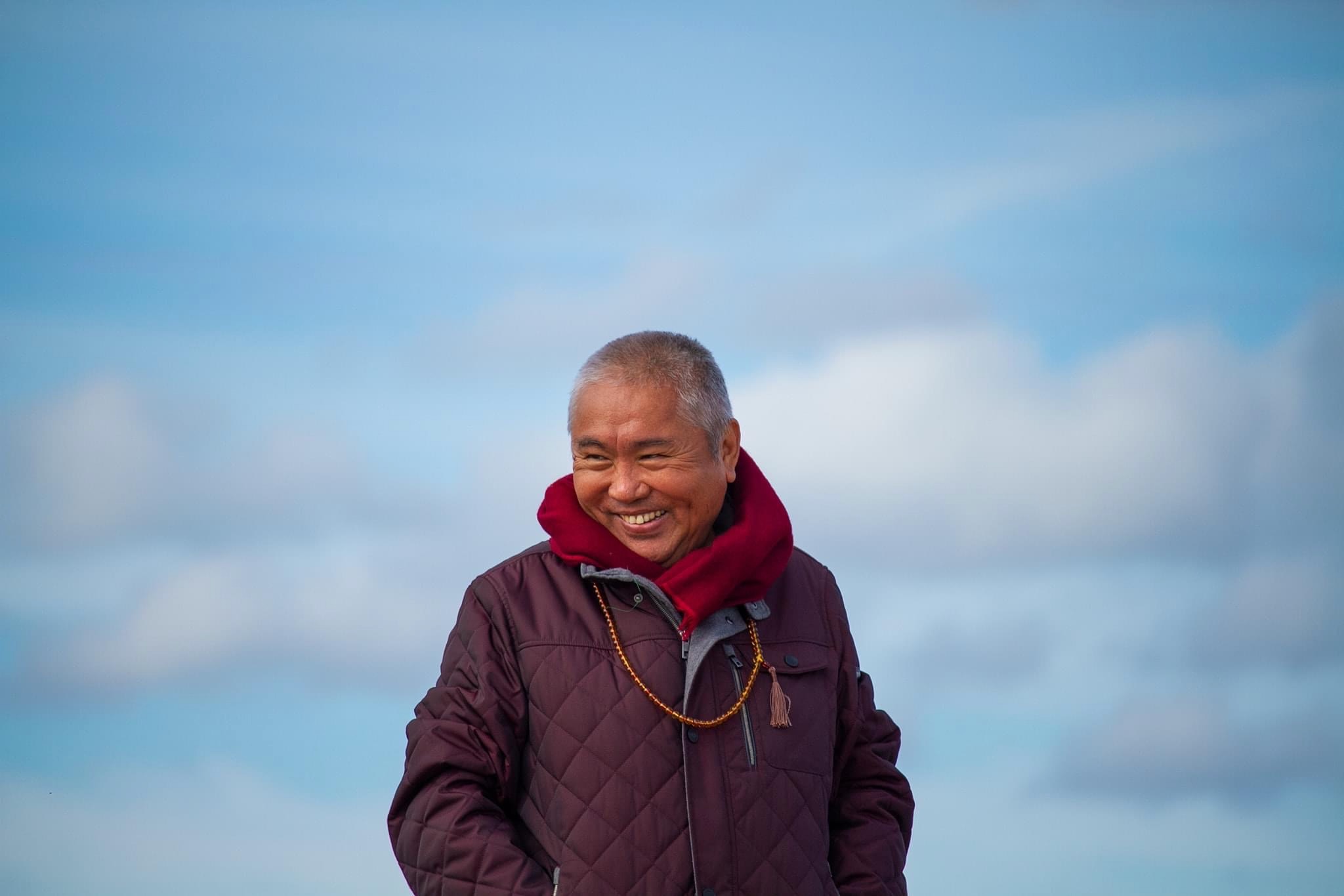 Nedo Kuchung Rinpoche beneath an open Himalayan sky